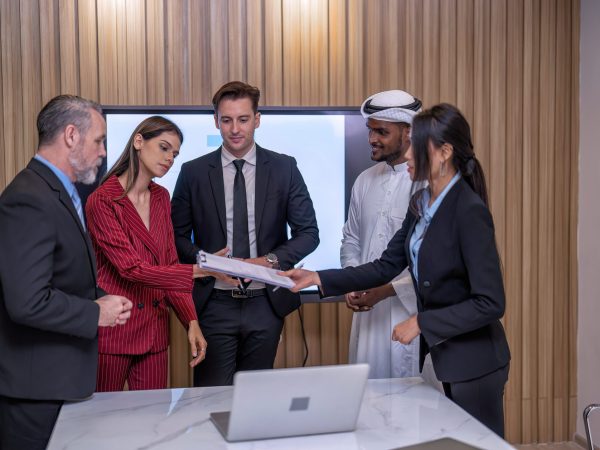 Group of business diversity people and middle east in office in the meeting room stand near big screen TV presentation contract agreement and signature close deal clap hands